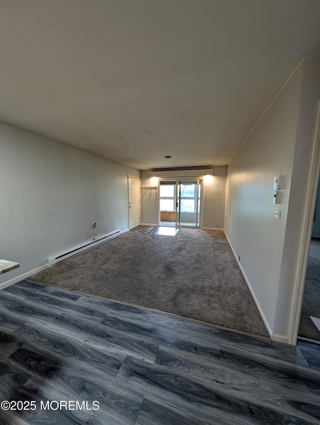 44J Cambridge Ct Unit 2010, Lakewood, NJ 08701 - empty room with a baseboard heating unit and dark wood-type flooring