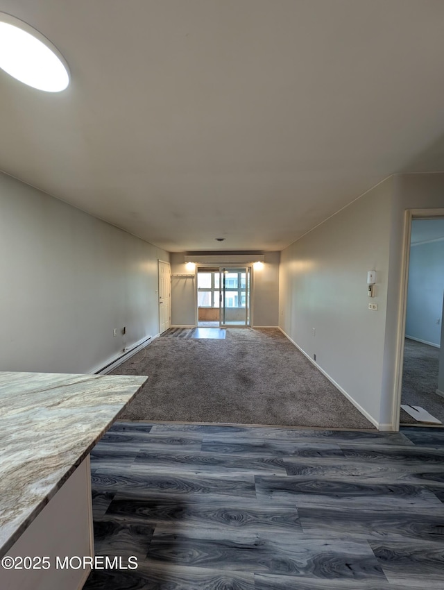 44J Cambridge Ct Unit 2010, Lakewood, NJ 08701 - unfurnished living room with dark wood-style flooring and baseboard heating