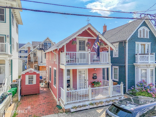 28 Olin St, Ocean Grove, NJ 07756 - view of front of house featuring a shed, covered porch, and a balcony