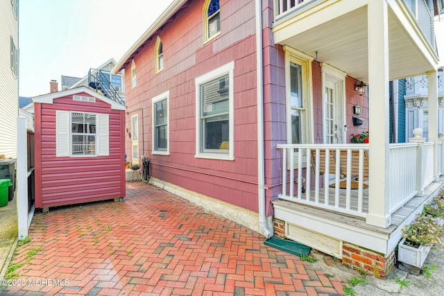 28 Olin St, Ocean Grove, NJ 07756 - view of home's exterior featuring a storage shed and a porch