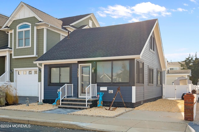 139 N St, Seaside Park, NJ 08752 - view of front of property featuring a shingled roof, a gate, and a garage