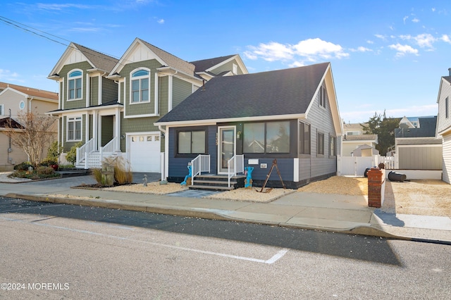 139 N St, Seaside Park, NJ 08752 - view of front of home with a shingled roof, driveway, and a garage