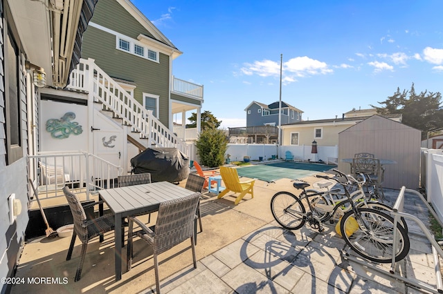 139 N St, Seaside Park, NJ 08752 - fenced backyard with a patio, stairway, outdoor dining space, and a storage unit