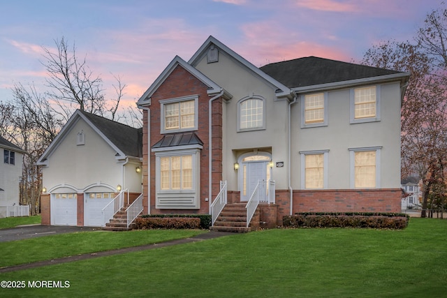 208 Imperial Ct, Lakewood, NJ 08701 - traditional-style house featuring brick siding, driveway, a front yard, stucco siding, and a garage