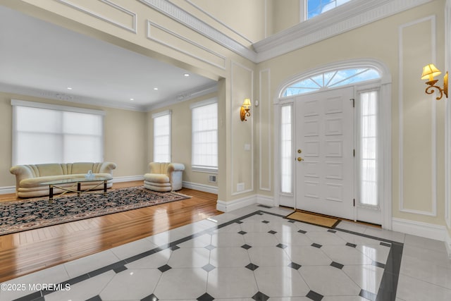 208 Imperial Ct, Lakewood, NJ 08701 - entrance foyer with inlaid floor details, healthy amount of natural light, crown molding, light tile patterned floors, and recessed lighting