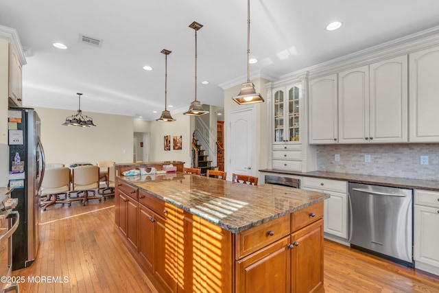 208 Imperial Ct, Lakewood, NJ 08701 - kitchen with ornamental molding, appliances with stainless steel finishes, a kitchen island, light wood-type flooring, and dark stone counters