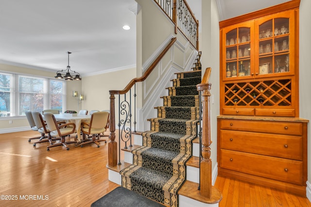 208 Imperial Ct, Lakewood, NJ 08701 - stairway with ornamental molding, hardwood / wood-style floors, and a chandelier