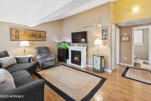 2015 Whitcomb Rd, Forked River, NJ 08731 - living area with wood finished floors, lofted ceiling, and a glass covered fireplace