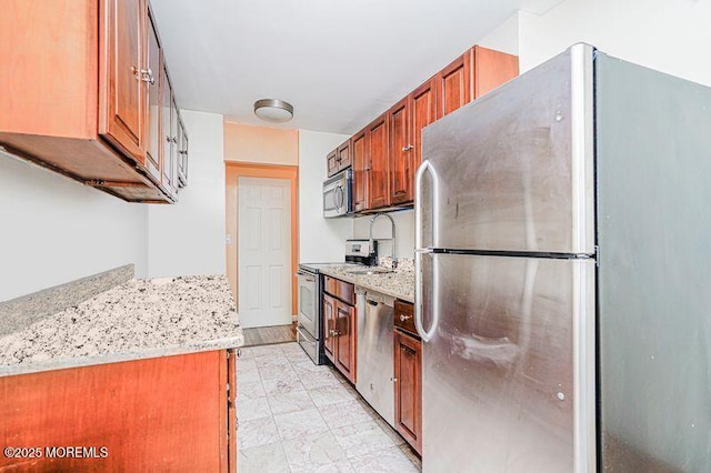 200 Winston Dr Unit 2921, Cliffside Park, NJ 07010 - kitchen with appliances with stainless steel finishes, brown cabinets, and light stone counters