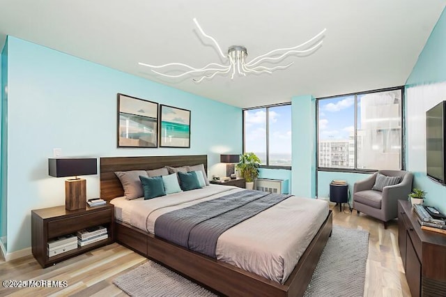 200 Winston Dr Unit 2921, Cliffside Park, NJ 07010 - bedroom with light wood-type flooring and a chandelier