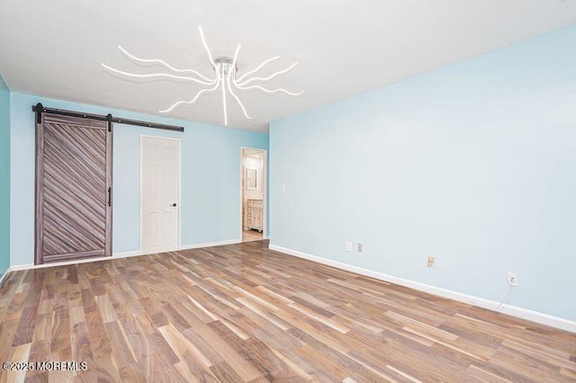 200 Winston Dr Unit 2921, Cliffside Park, NJ 07010 - unfurnished bedroom with wood finished floors, a barn door, and ensuite bath