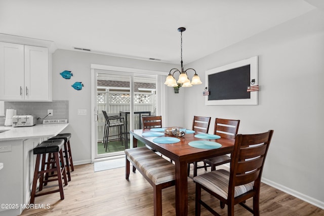 1301 SW Central Ave Unit A3, Seaside Park, NJ 08752 - dining space with light wood-style flooring and a chandelier