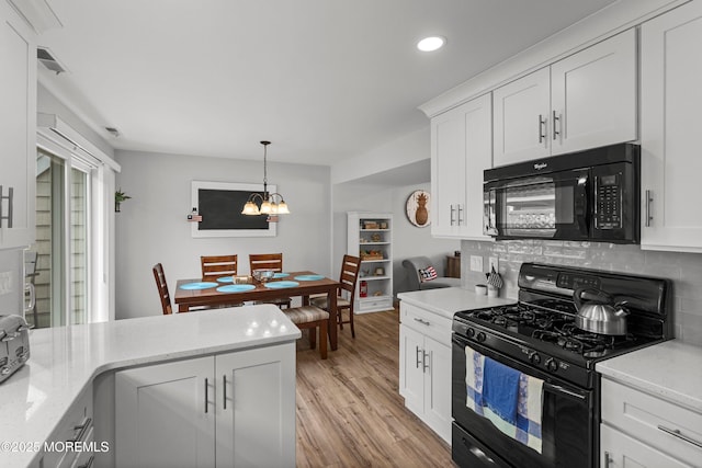 1301 SW Central Ave Unit A3, Seaside Park, NJ 08752 - kitchen with black appliances, backsplash, recessed lighting, light wood-type flooring, and white cabinets