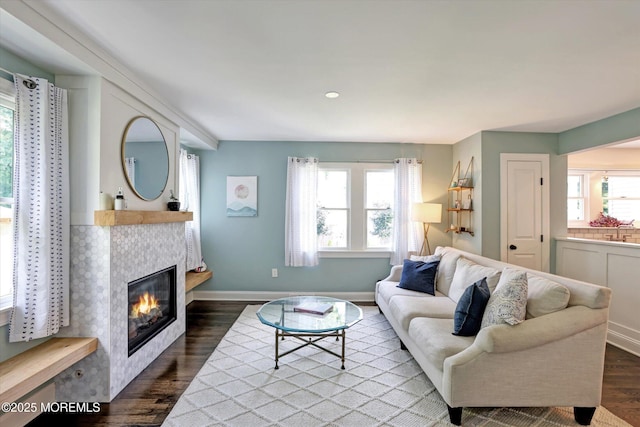 708 Lyman Ave, Brielle, NJ 08730 - living area featuring dark wood-style floors, plenty of natural light, and a fireplace