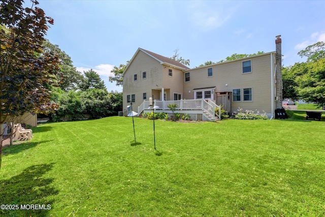 708 Lyman Ave, Brielle, NJ 08730 - rear view of house featuring a chimney, a wooden deck, a yard, and stairway