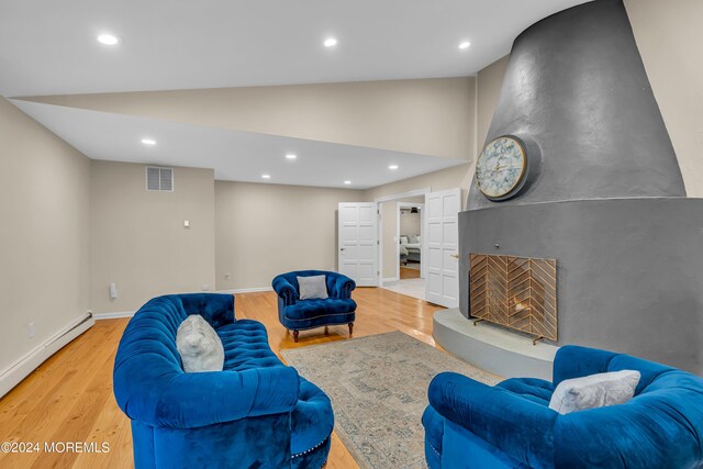 222 Bartley Rd, Jackson, NJ 08527 - living room featuring light wood-style floors, high vaulted ceiling, a baseboard heating unit, recessed lighting, and a large fireplace