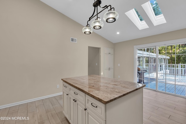 222 Bartley Rd, Jackson, NJ 08527 - kitchen featuring a skylight, wood tiled floors, light stone countertops, a center island, and recessed lighting