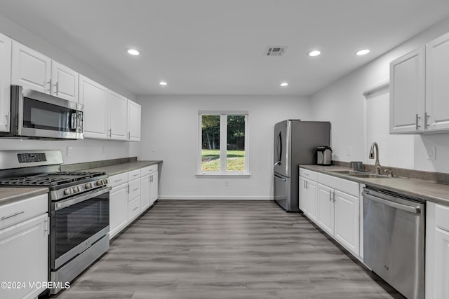 222 Bartley Rd, Jackson, NJ 08527 - kitchen with appliances with stainless steel finishes, recessed lighting, white cabinets, and light wood-style floors