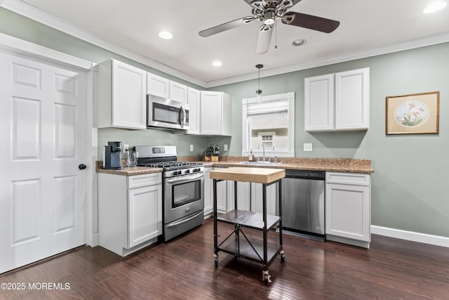 49 Highland Ave, Leonardo, NJ 07737 - kitchen with stainless steel appliances, white cabinets, crown molding, dark wood-type flooring, and a ceiling fan