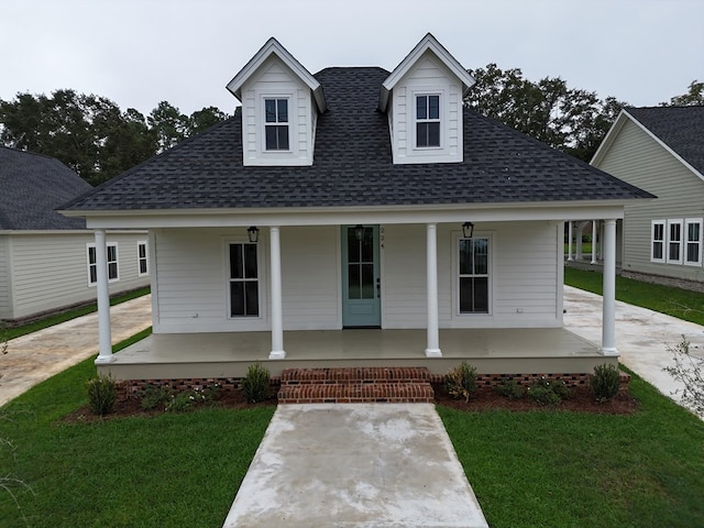 view of front of house featuring a front yard and covered porch