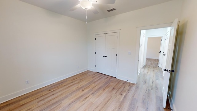 unfurnished bedroom with a closet, ceiling fan, and light wood-type flooring