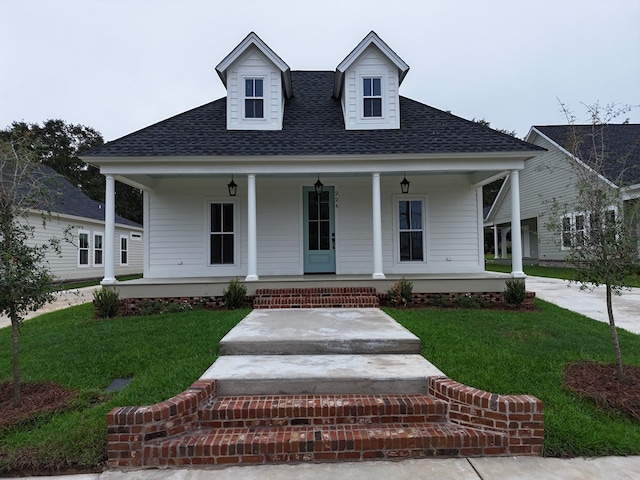 view of front of home featuring a front yard and covered porch