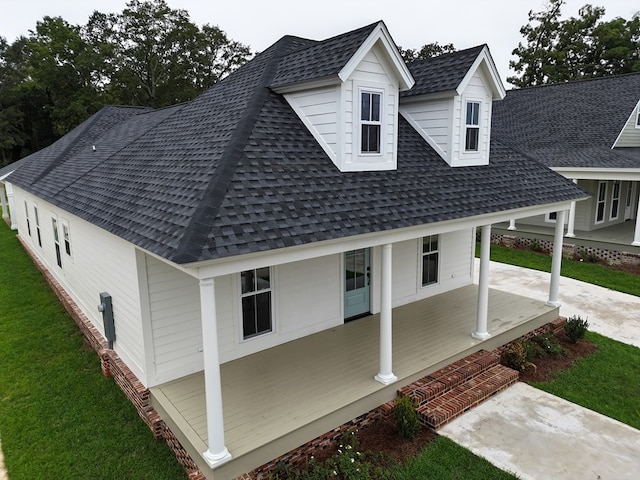 back of house featuring a yard and a porch