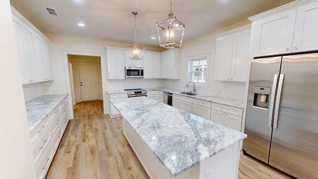 kitchen featuring white cabinetry, appliances with stainless steel finishes, and sink