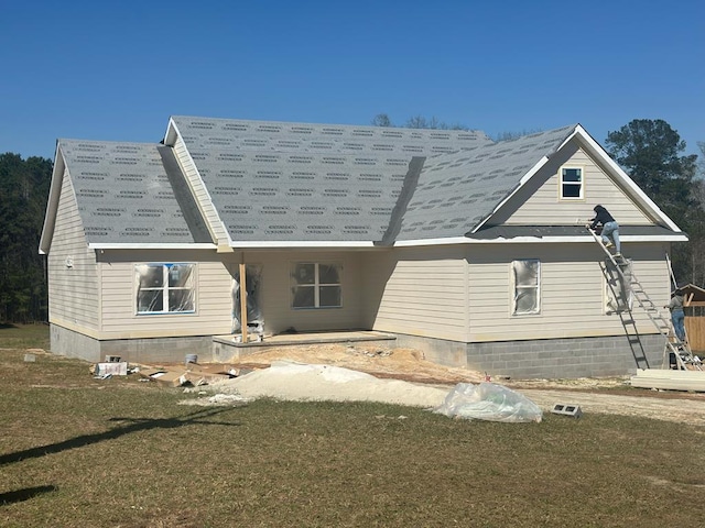 rear view of house with a yard