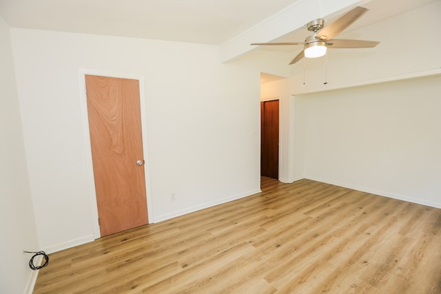 empty room featuring a ceiling fan, baseboards, and wood finished floors