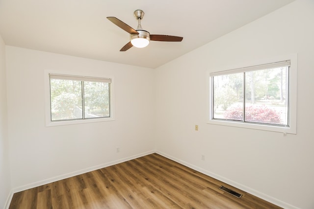 unfurnished room with baseboards, ceiling fan, visible vents, and wood finished floors