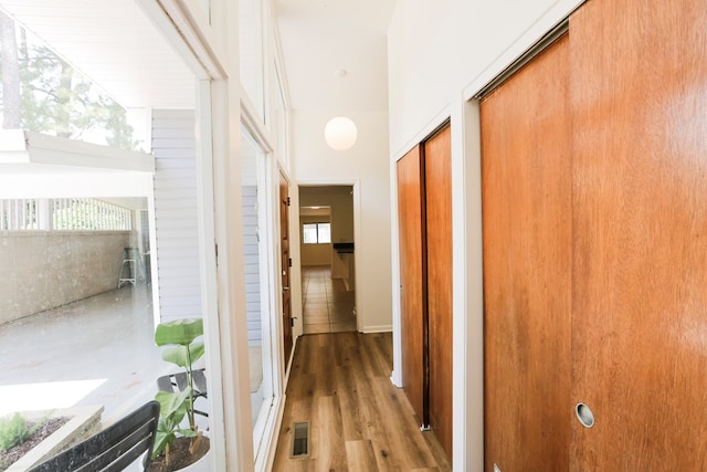 corridor with visible vents and wood finished floors