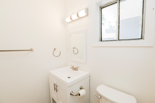 bathroom with toilet and vanity