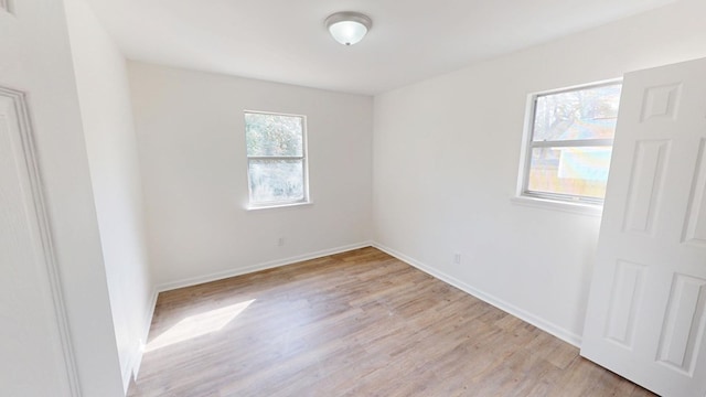 empty room featuring light wood-style flooring and baseboards