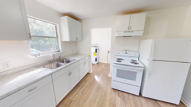 kitchen featuring white appliances, white cabinets, under cabinet range hood, water heater, and a sink