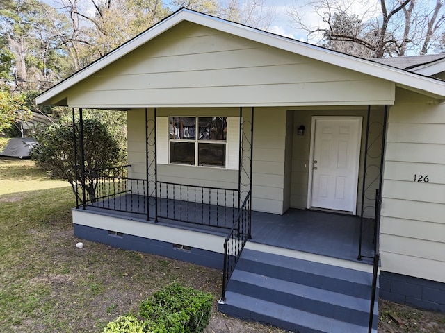 bungalow-style home featuring a porch and crawl space