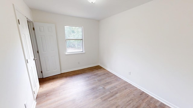 unfurnished bedroom featuring baseboards and light wood-style floors