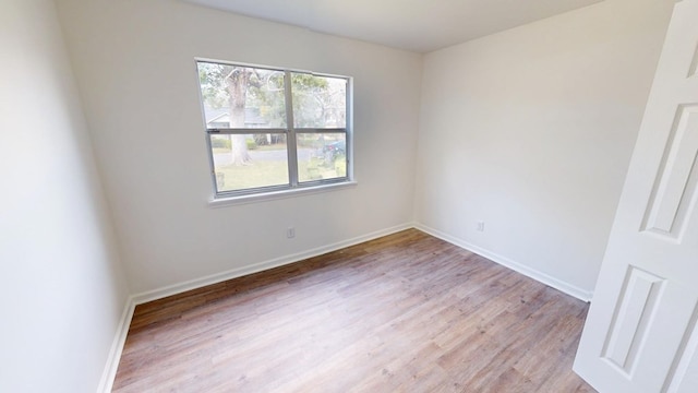 empty room featuring light wood-style floors and baseboards