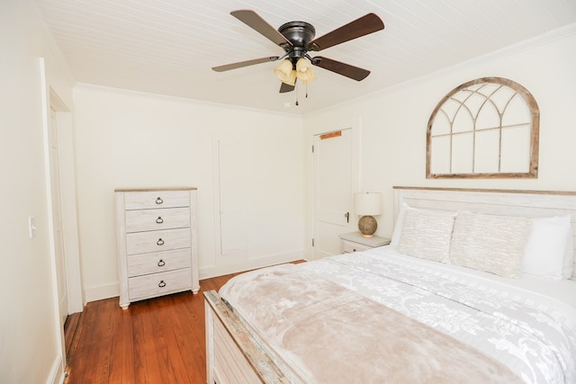 bedroom with baseboards, crown molding, a ceiling fan, and dark wood-style flooring