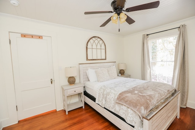 bedroom featuring crown molding, ceiling fan, and wood finished floors