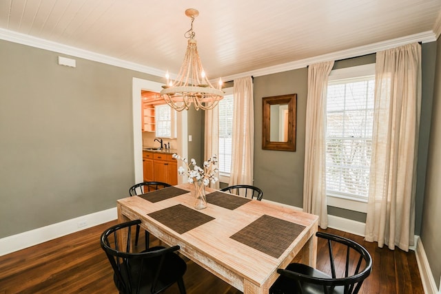 dining area featuring dark wood finished floors, crown molding, and baseboards