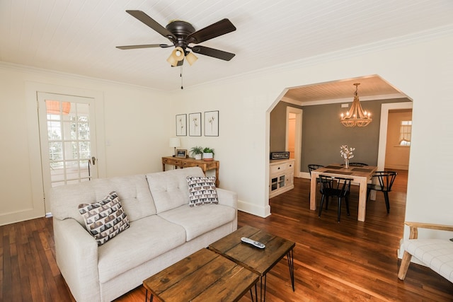 living area featuring baseboards, dark wood finished floors, arched walkways, ornamental molding, and ceiling fan with notable chandelier