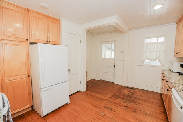 kitchen with white appliances, crown molding, and light brown cabinetry