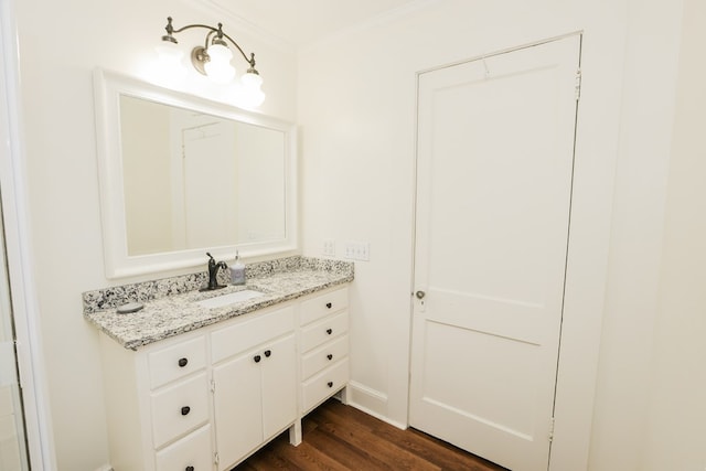 bathroom featuring vanity, wood finished floors, and ornamental molding