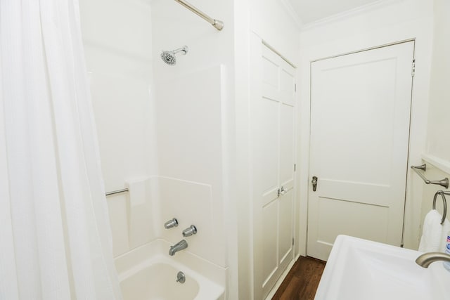 full bath with wood finished floors, shower / bath combo with shower curtain, and ornamental molding