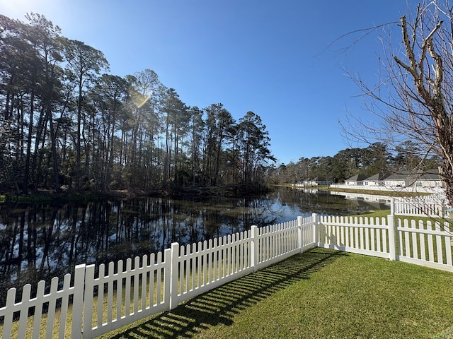 view of yard with fence and a water view