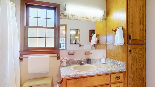bathroom featuring vanity, toilet, and a shower with curtain
