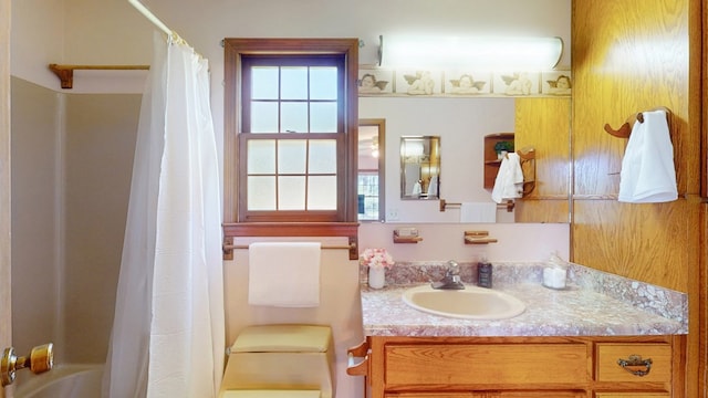 bathroom with vanity, toilet, and shower / tub combo