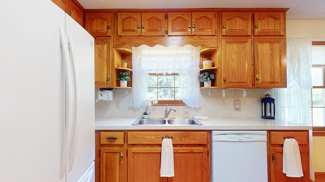 kitchen featuring white appliances, open shelves, a sink, and light countertops
