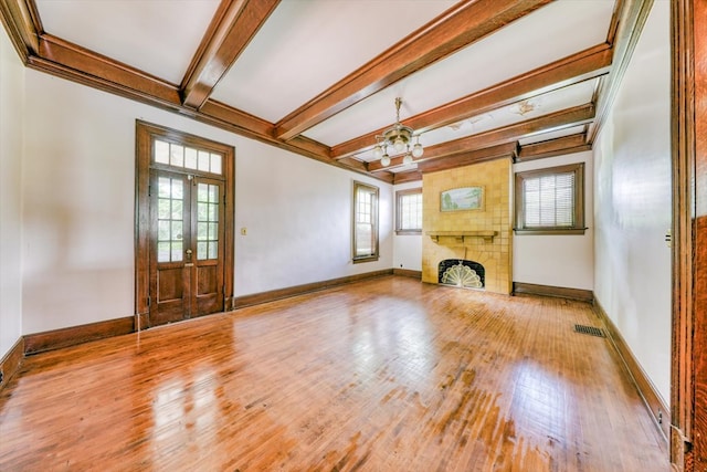 902 SE 2nd St, Moultrie, GA 31776 - unfurnished living room featuring a chandelier, wood finished floors, beam ceiling, a fireplace, and baseboards